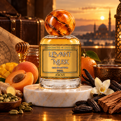 AWAY by Levant Musk on a cream marble pedestal in a warm sunset setting with honey, apricot, mango, tangerine, ginger, cardamom, vanilla, tonka beans and cedarwood.