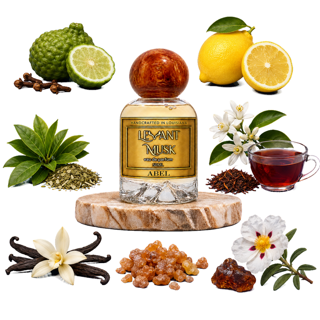 A bottle of Levant Musk eau de parfum labeled Abel centered on a white background, surrounded by its natural ingredients including lemongrass, kumquats, lemons, vanilla flowers, vanilla pods, rooibos tea leaves, and a cup of brewed tea.