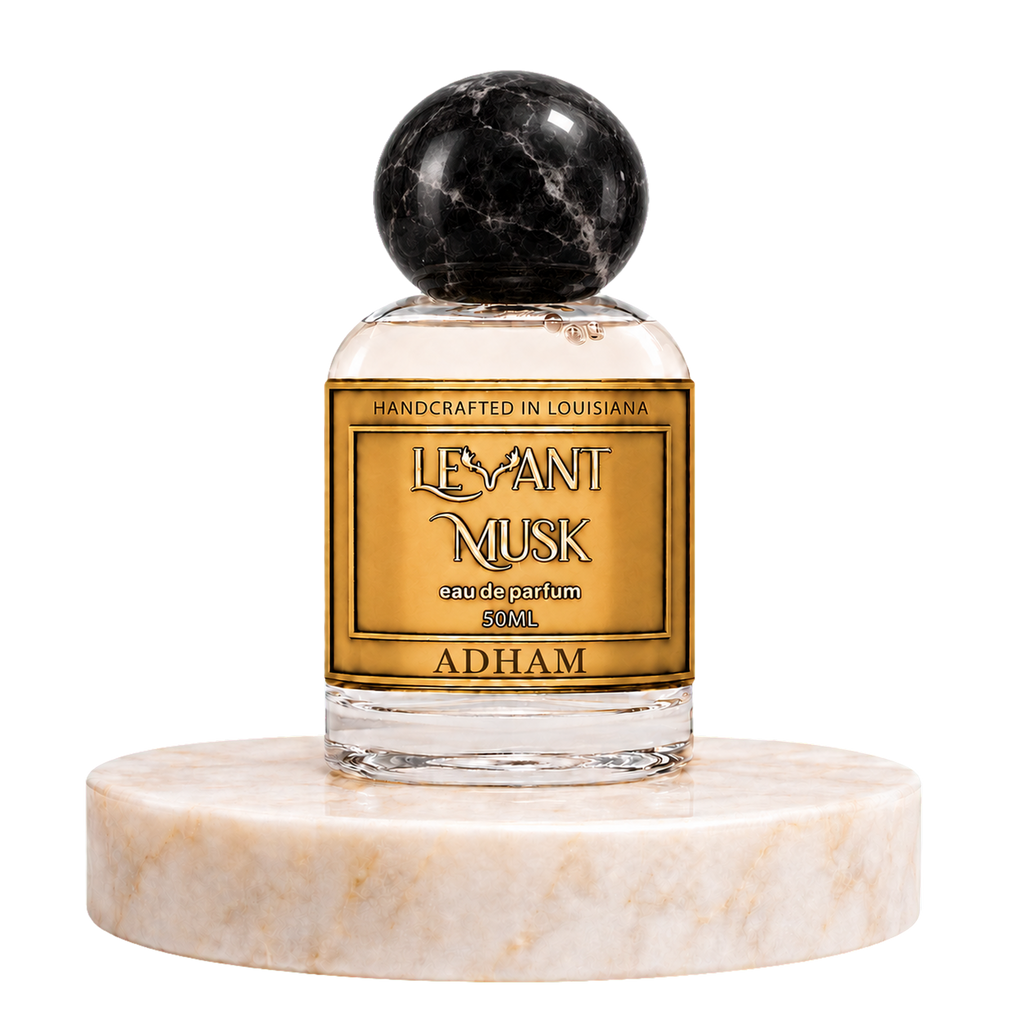 ADHAM 50 mL eau de parfum by Levant Musk, with a black marble-patterned round cap, on a marble pedestal.