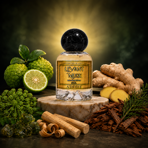ADORE perfume with black marble spherical cap, bergamot, ginger, galbanum, sandalwood and cedar beneath a warm golden glow.