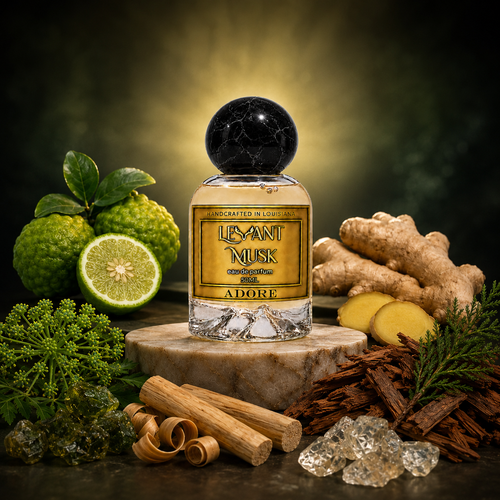 A bottle of Levant Musk fragrance labeled 'ADORE' stands on a stone slab, surrounded by citrus, ginger, cinnamon, resin, and greenery against a dark glowing background.