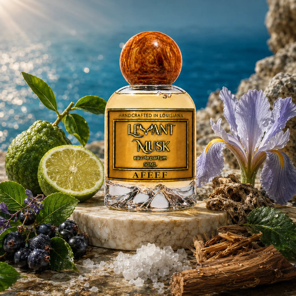 AFEEF by Levant Musk perfume with bergamot, dark berries, iris, crystals and wood on a rocky ledge above blue water.