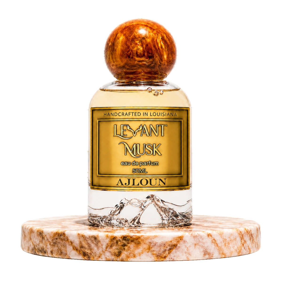 A bottle of AJLOUN eau de parfum by Levant Musk centered on a white background, resting on a round marble coaster. The bottle has a gold label with black text, a clear lower section showing water droplets, and a polished amber-brown wooden cap.