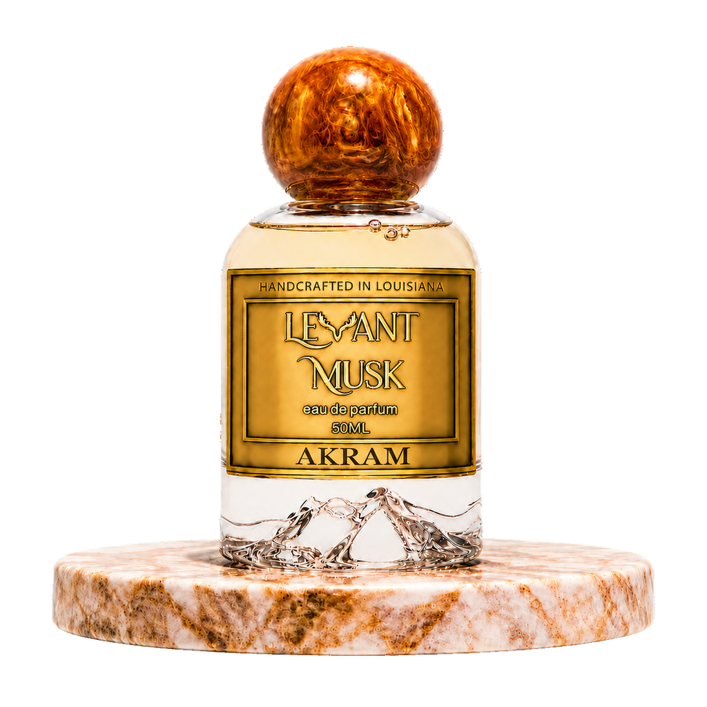 A 50ml bottle of Akram by Levant Musk eau de parfum, featuring a clear glass body with a gold label and a round, polished brown wood-grain cap, displayed on a matching marble base against a white background.