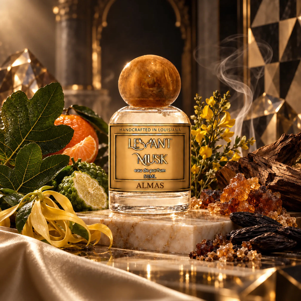 A perfume bottle labeled 'Levant Musk' eau de parfum named 'Almas' sits on a marble slab in a richly styled setting with citrus fruits, green leaves, yellow flowers, crystals, and dark wood, under warm dramatic lighting.