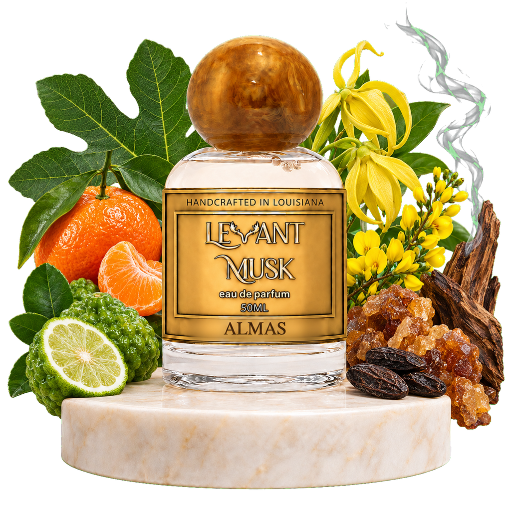 A perfume bottle labeled 'LEVANT MUSK' labeled ALMAS, styled on a white marble pedestal with citrus fruits, fig leaves, yellow flowers, and amber crystals against a black background.