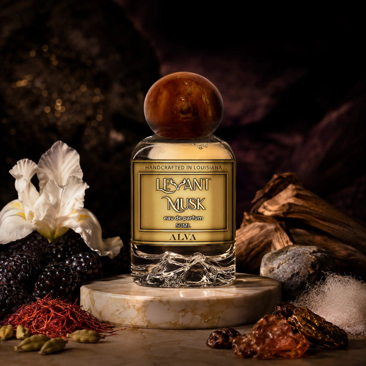 A bottle of ALVA by Levant Musk Eau de Parfum centered on a marble pedestal, surrounded by dark berries, a white flower, spices, and wood against a dark atmospheric background.