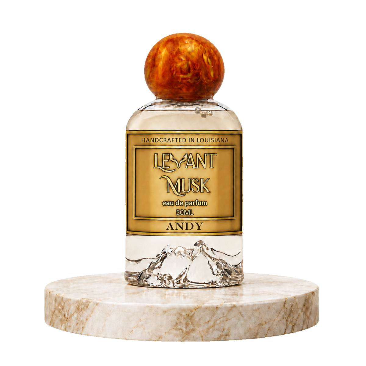 A clear glass perfume bottle with a round amber-brown cap, featuring a gold label that reads  'ANDY' eau da parfum by Levant Musk. The bottle is displayed on a round beige marble pedestal against a solid white background.
