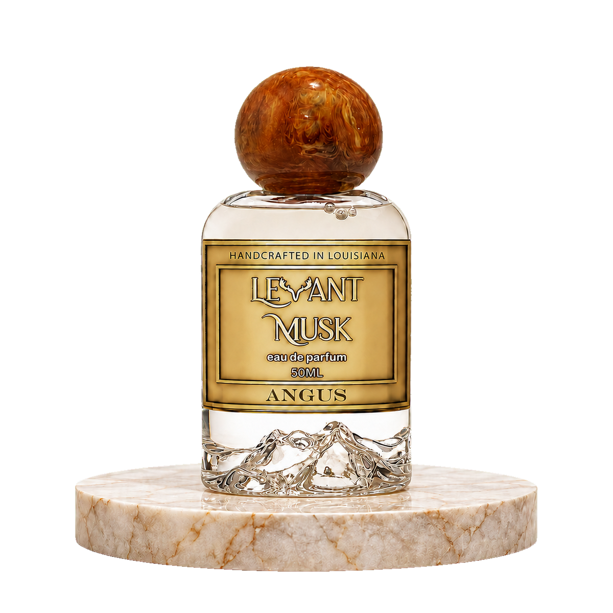 Angus by Levant Musk Eau de Parfum 50ml bottle with a round amber cap, displayed on a white marble pedestal against a white background.