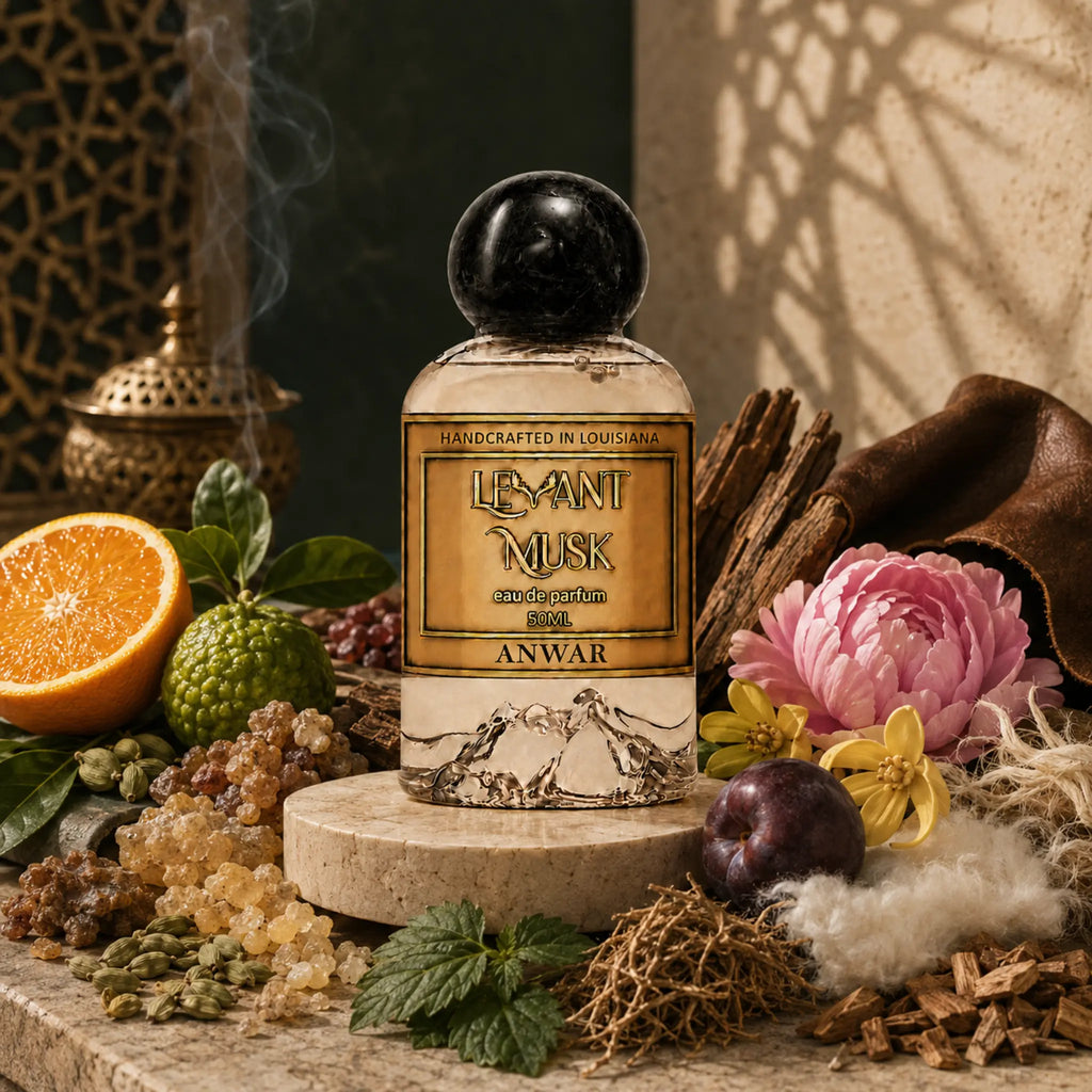 A perfume bottle labeled  ANWAR by Levant Musk  is centered on a stone pedestal, surrounded by fragrance ingredients including an orange, green berries, mint, cinnamon, flowers, and fur, in a styled studio scene.