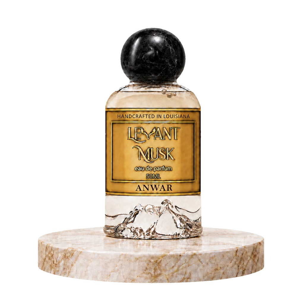 A bottle of Anwar by Levant Musk Eau de Parfum with a black marble cap and a gold label, displayed on a round beige marble pedestal against a white background.