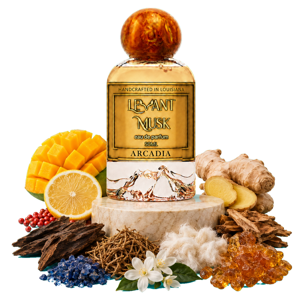 A bottle of Arcadia by Levant Musk eau de parfum centered on a white background, surrounded by fragrance ingredients including mango, lemon, ginger, resins, herbs, cotton, blue flowers, and amber pieces. The bottle has a gold label with mountain artwork and a round amber-toned cap.