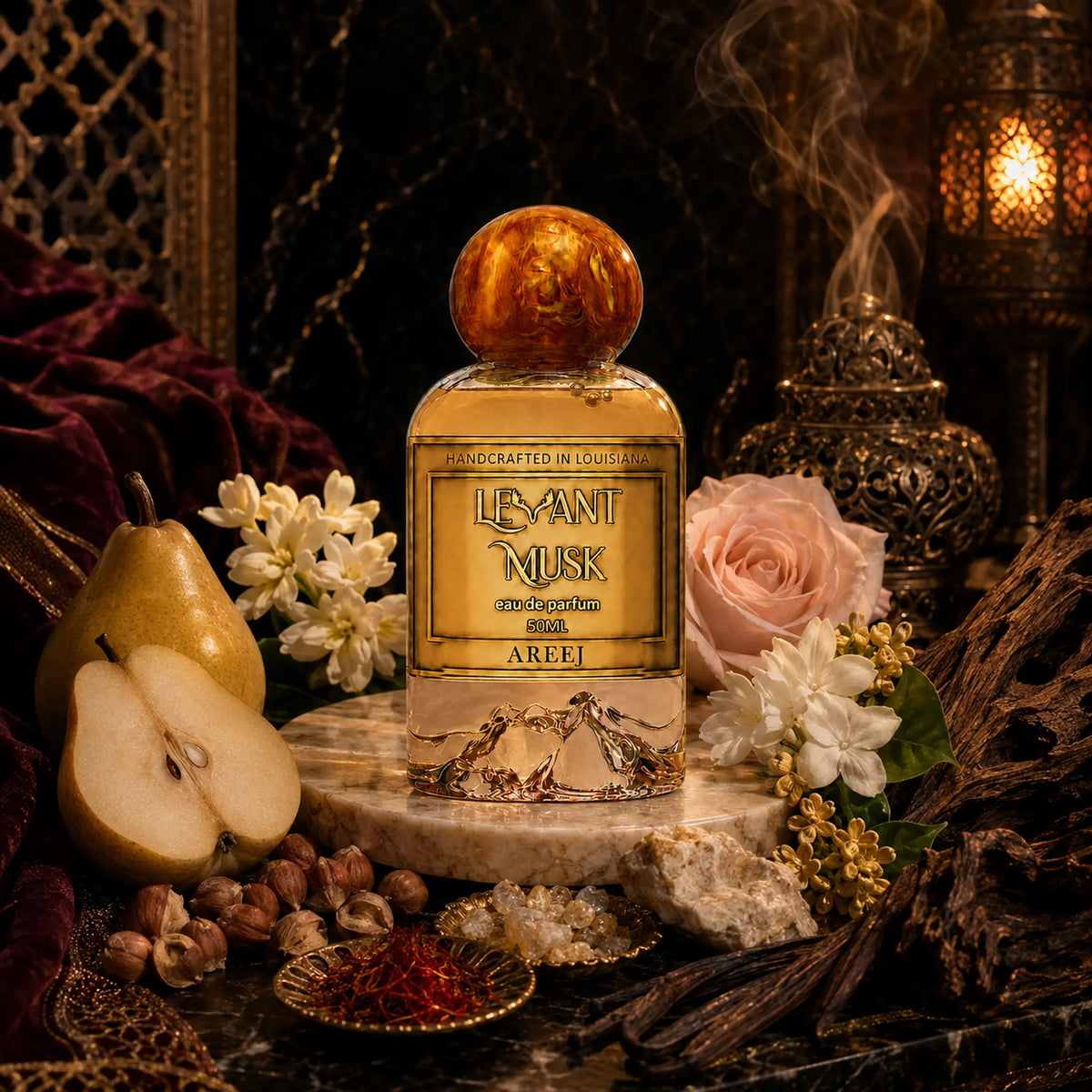 A perfume bottle labeled AREEJ, by Levant Musk, Monroe, LA styled in a rich, dark, luxurious setting with a pear, white flowers, a pink rose, hazelnuts, and a burning incense burner in the background.