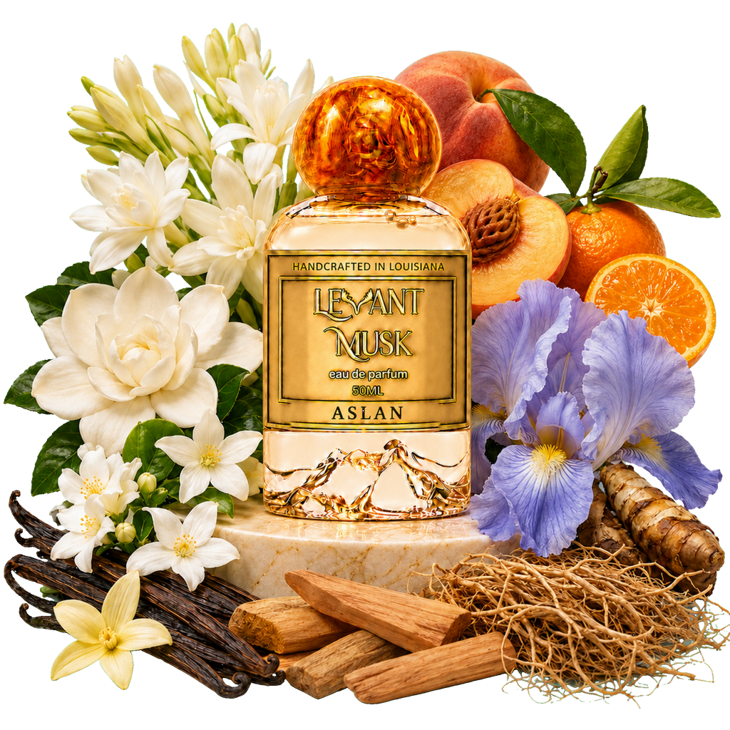 A perfume bottle labeled ASLAN, by Levant Musk, Monroe, LA styled with white flowers, peaches, oranges, vanilla beans, wood/vanilla/vetiver, and purple irises on a white background.