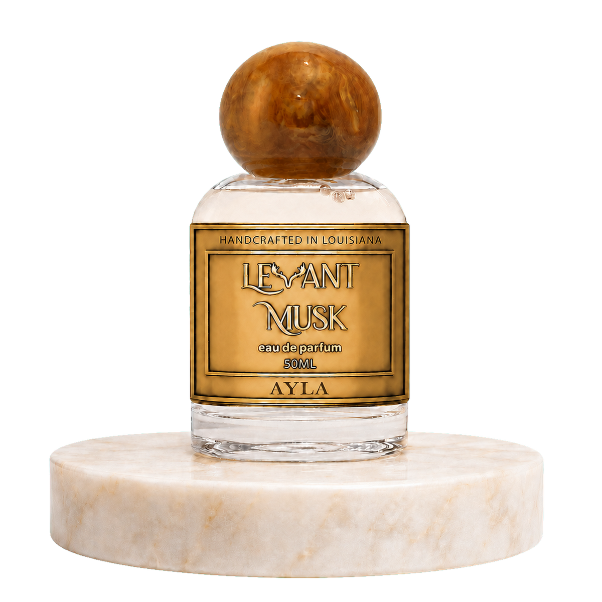 A 50ml bottle of Ayla by'Levant Musk' handcrafted perfume, featuring a clear glass bottle with a round brown wooden cap and a gold label, displayed on a white marble pedestal against a white background.