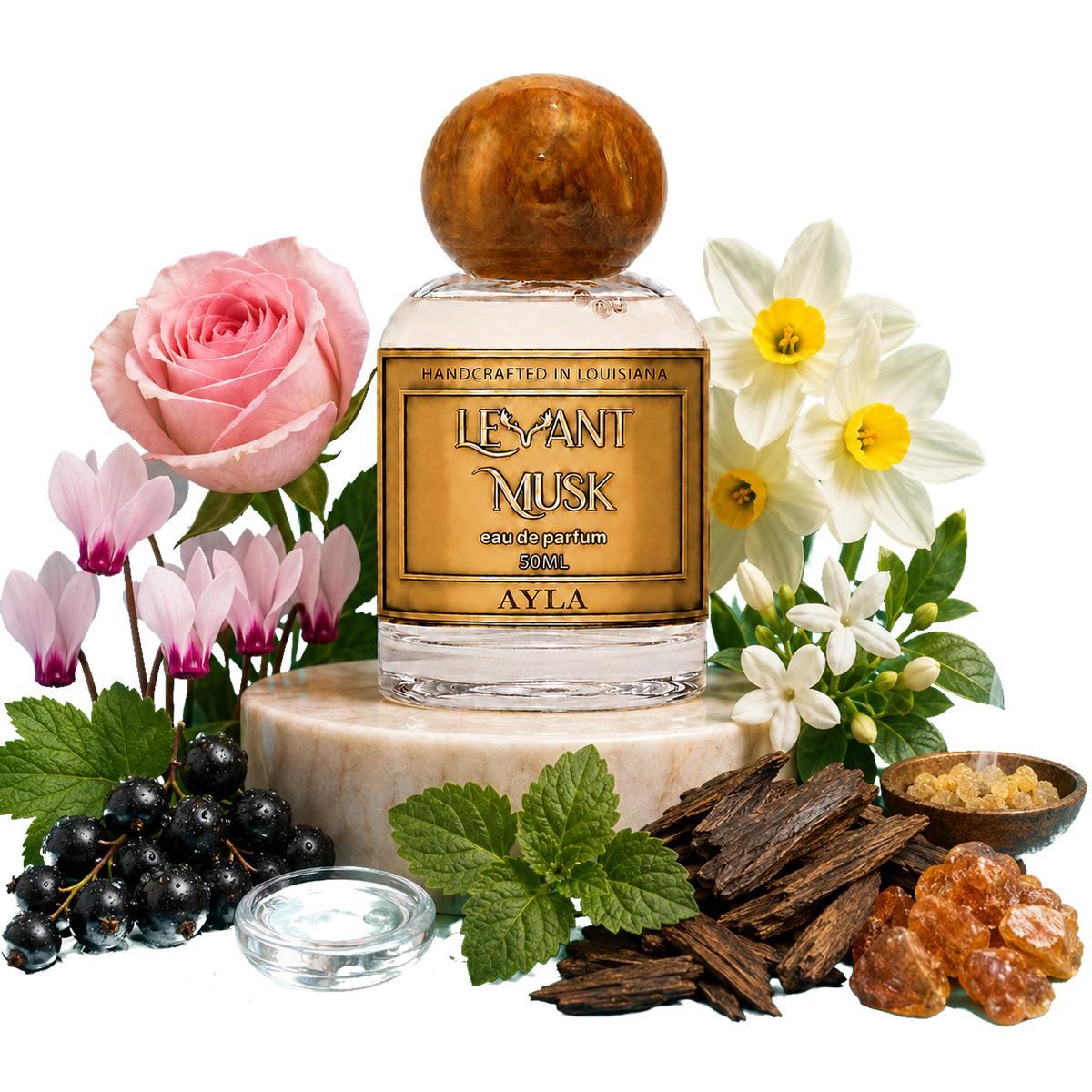 A 50 ml bottle of Ayla by Levant Musk, Monroe, LA centered on a white background, styled with rose, daffodil, cyclamen, blackcurrant, mint, wood chips, and amber pieces around it. The bottle has a gold label and a round wooden cap.