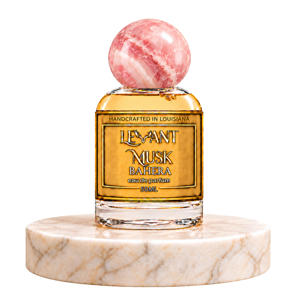 BAHERA 50 mL eau de parfum by Levant Musk with a pink marble cap and Louisiana label, on a round marble pedestal with a transparent background.