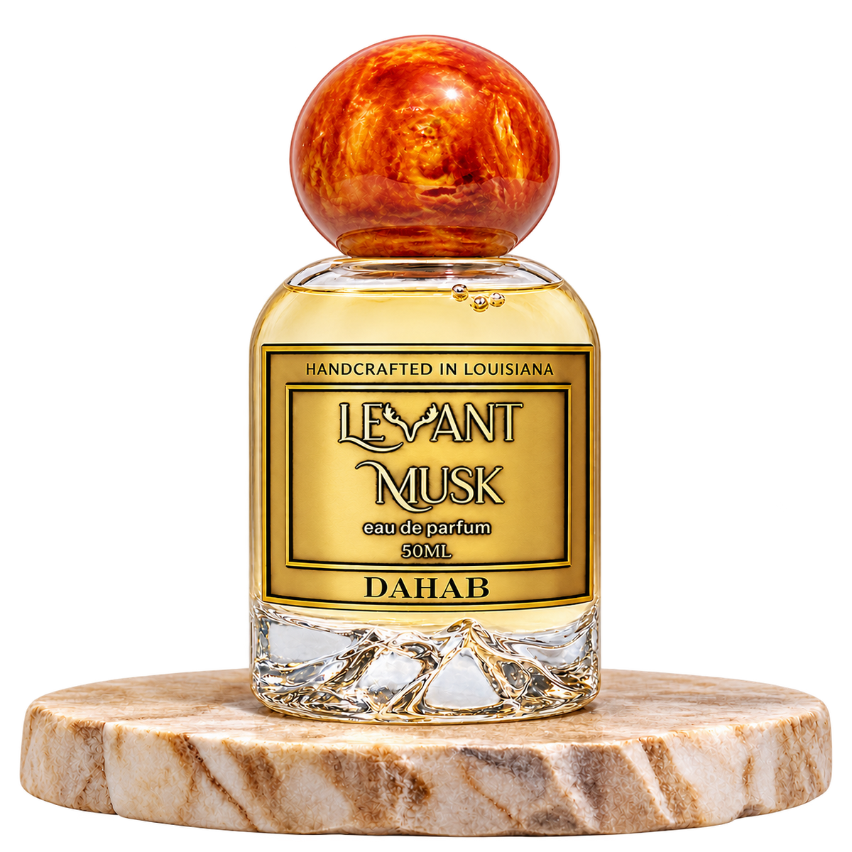 DAHAB by Levant Musk, 50 mL bottle with orange-gold cap on a marble pedestal