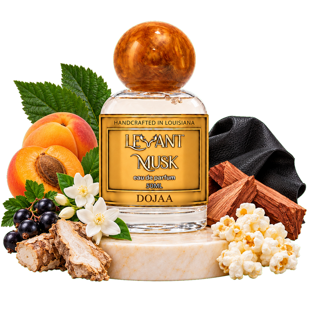 A bottle of DOJAA Levant Musk one 50 ml perfume, styled with its scent ingredients including apricots, peaches, white flowers, cinnamon, blackcurrants, popcorn, and a black leather square on a white marble base.