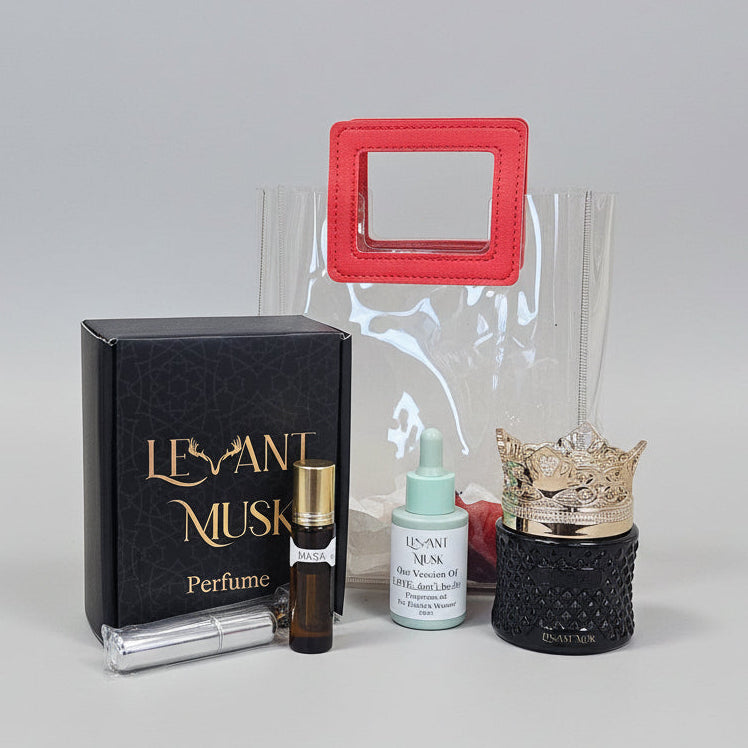 Levant Musk Deluxe Gift Set with boxed perfume, roll-on oil, home fragrance oil, silver travel atomizer and black cream jar with gold crown lid.
