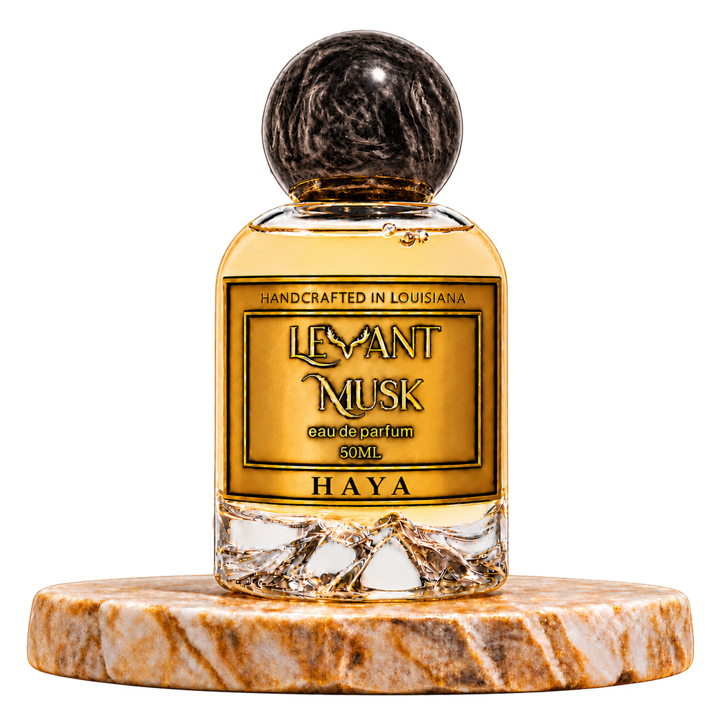 HAYA by Levant Musk, 50 mL eau de parfum with a round black marbled cap and gold label, on a marble pedestal with a transparent background.
