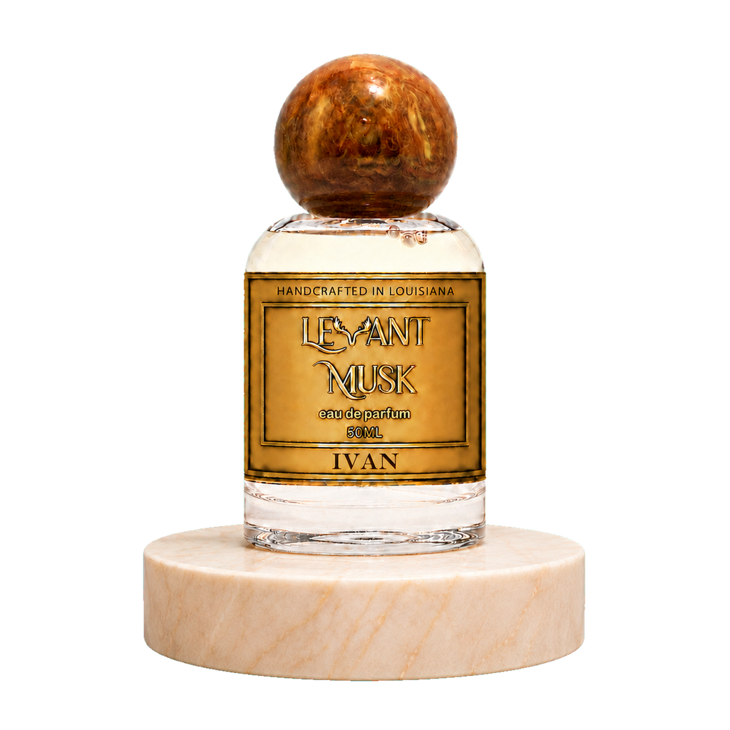 A 50 mL bottle of 'Ivan' eau de parfum by Levant Musk handcrafted perfume, featuring a round amber cap and a gold label, displayed on a round beige marble pedestal against a white background.