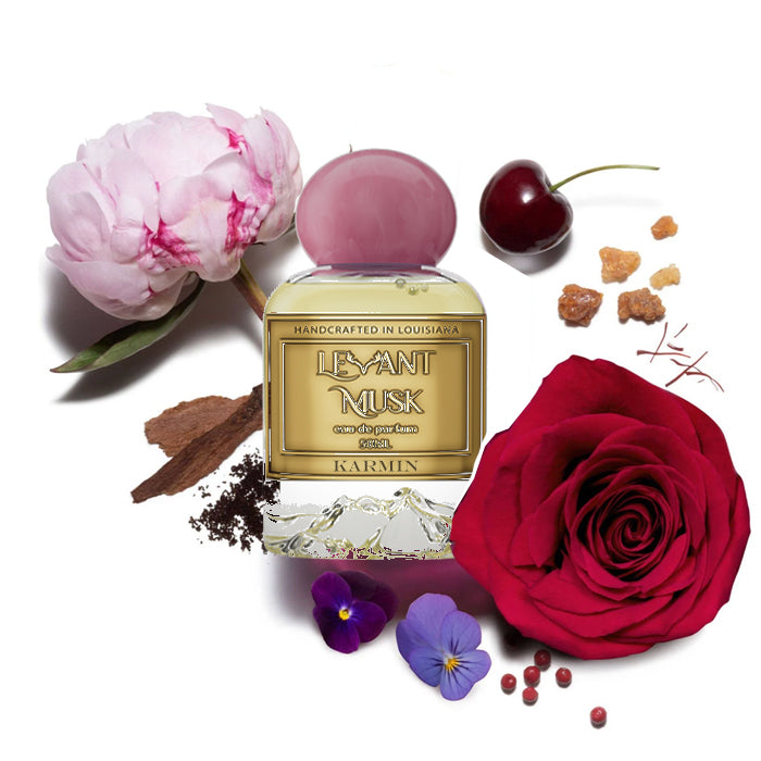 Karmin fragrance styled with notes of black cherry, rose de mai, and musk