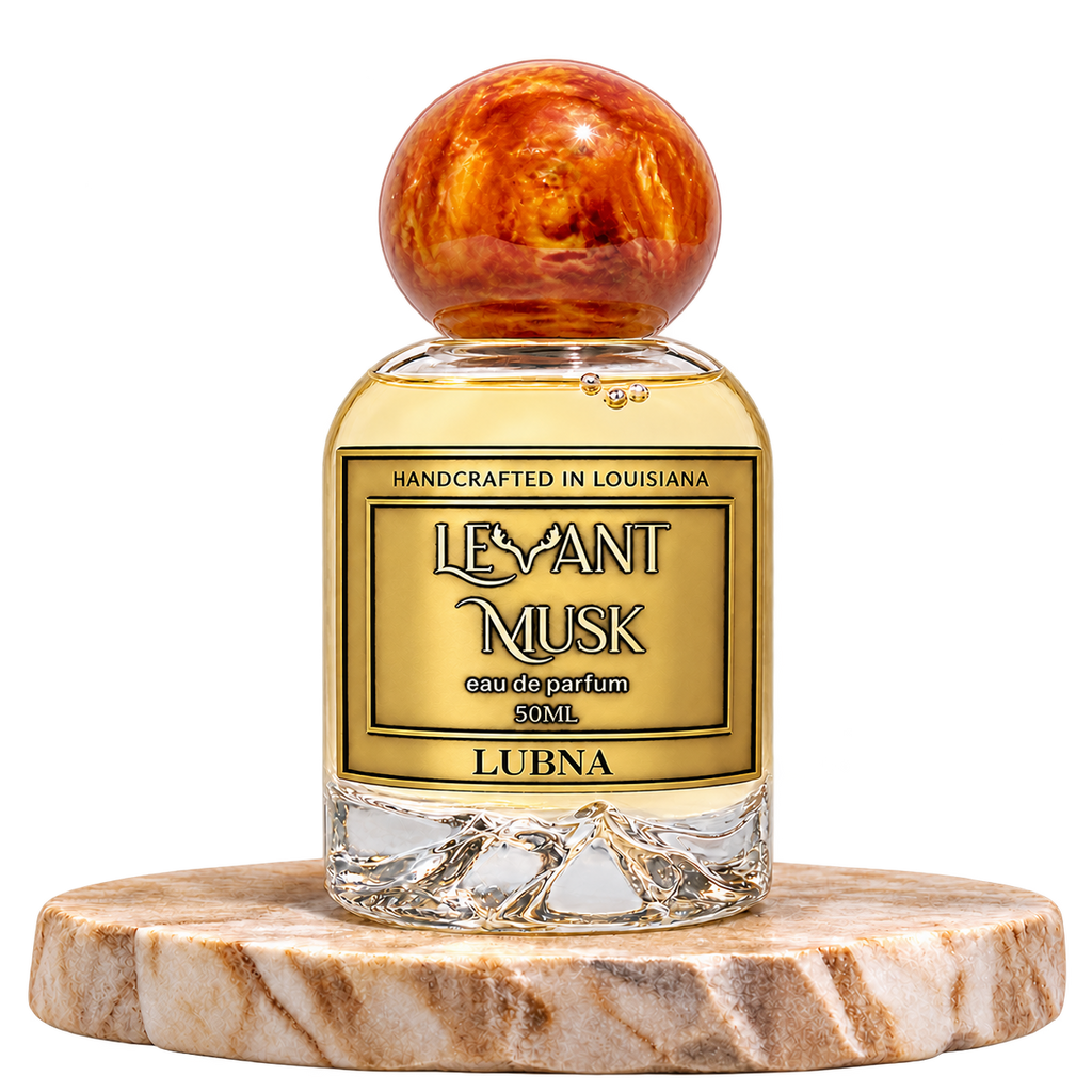 LUBNA by Levant Musk, 50 mL bottle with orange-gold cap on a marble pedestal