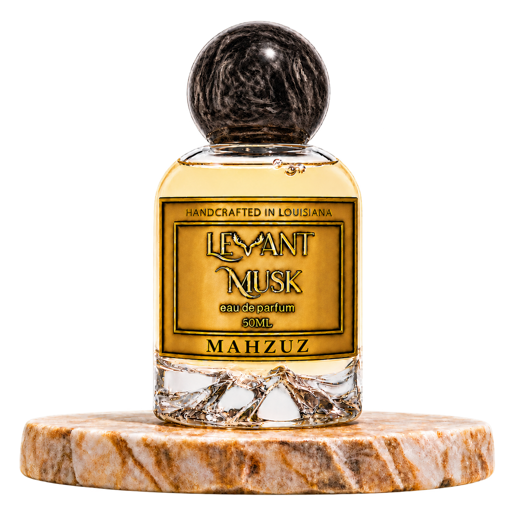 MAHZUZ by Levant Musk, 50 mL eau de parfum with black marbled cap on a marble pedestal, transparent background
