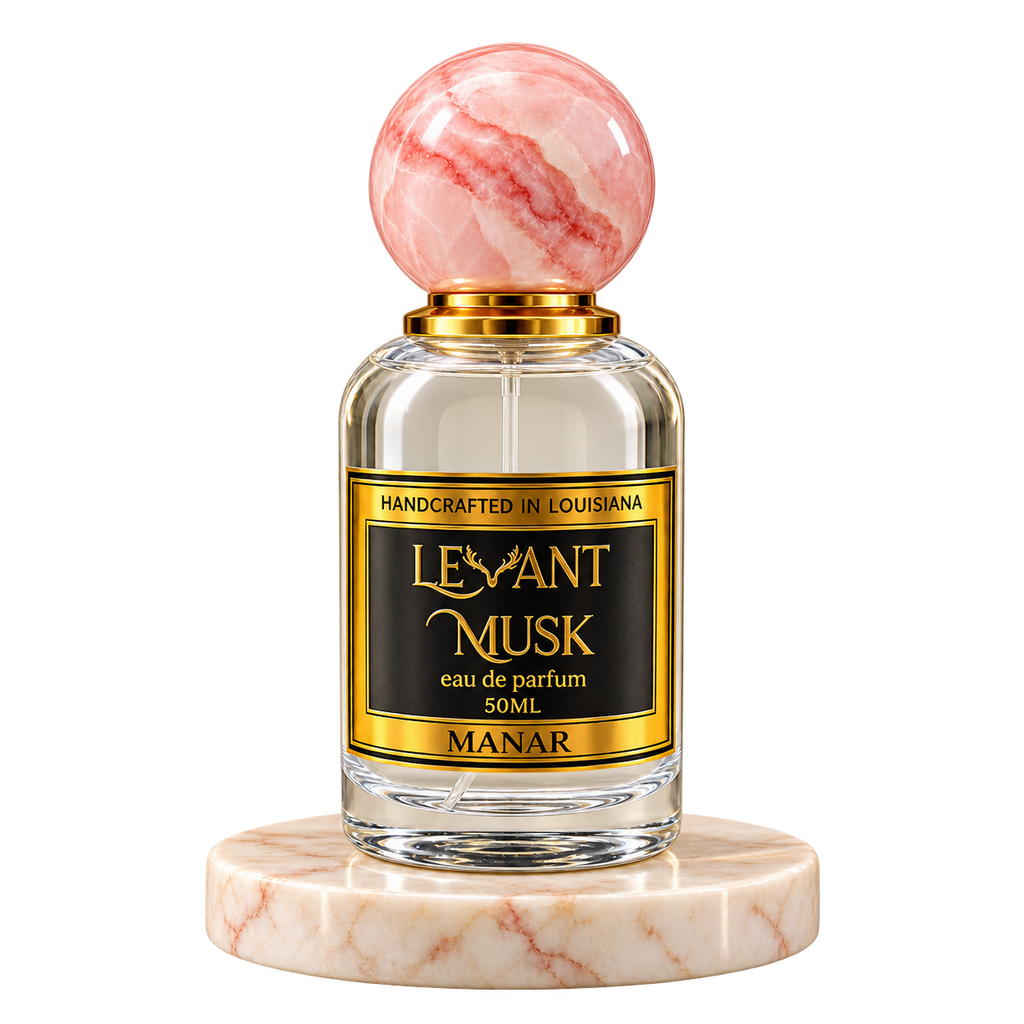 MANAR by Levant Musk, 50 mL eau de parfum with a pink marble cap on a cream marble plinth, transparent background.