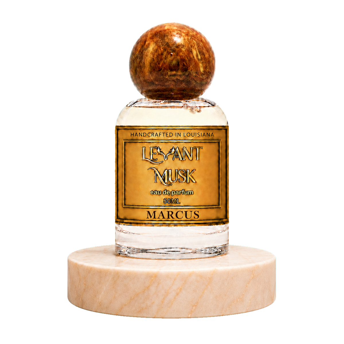 A 50ml bottle of Marcus eau de parfum by Levant Musk, featuring a clear glass bottle with a gold label, topped with a polished brown wooden sphere cap and resting on a round white marble base, set against a plain white background.