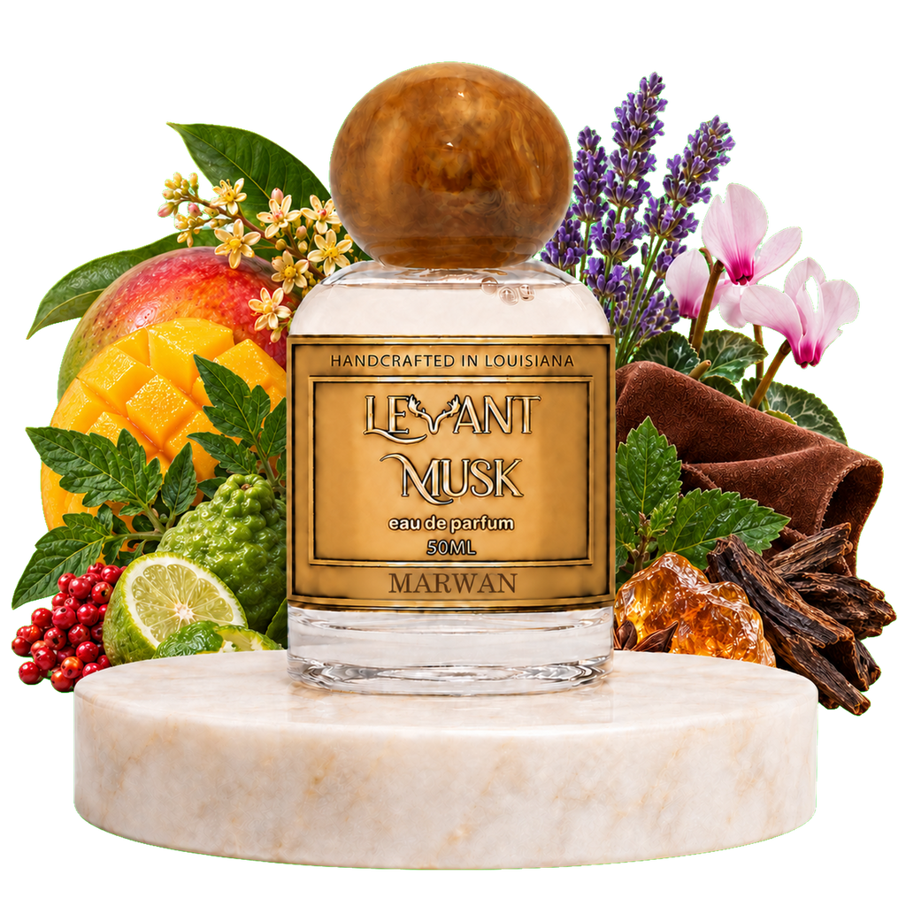 A perfume bottle labeled 'LEVANT MUSK' eau de parfum Marwan, displayed on a white marble pedestal with a rich assortment of fragrance notes including a mango, lime, rose, lavender, cinnamon, and amber crystals.
