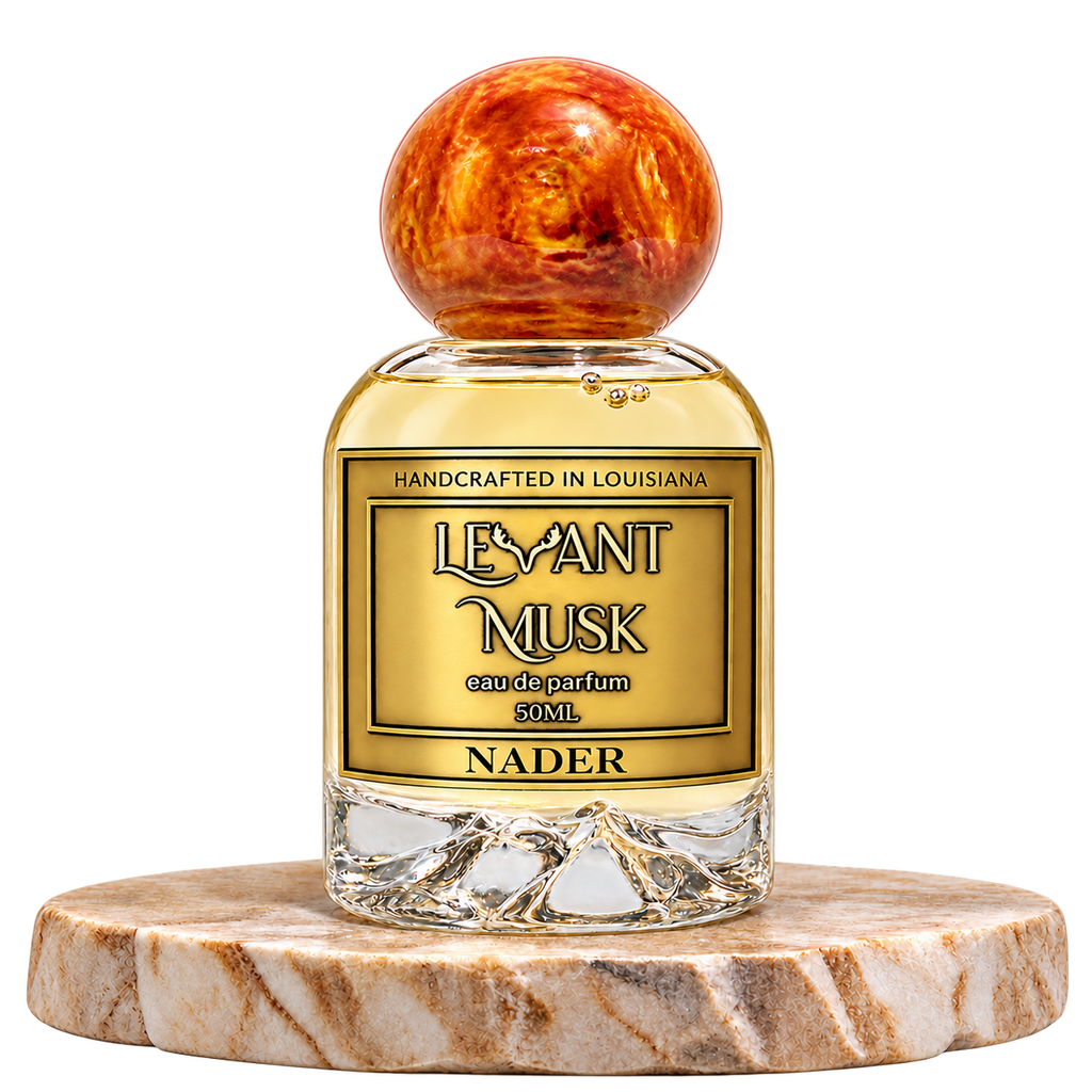 NADER by Levant Musk, 50 mL bottle with orange-gold cap on a marble pedestal