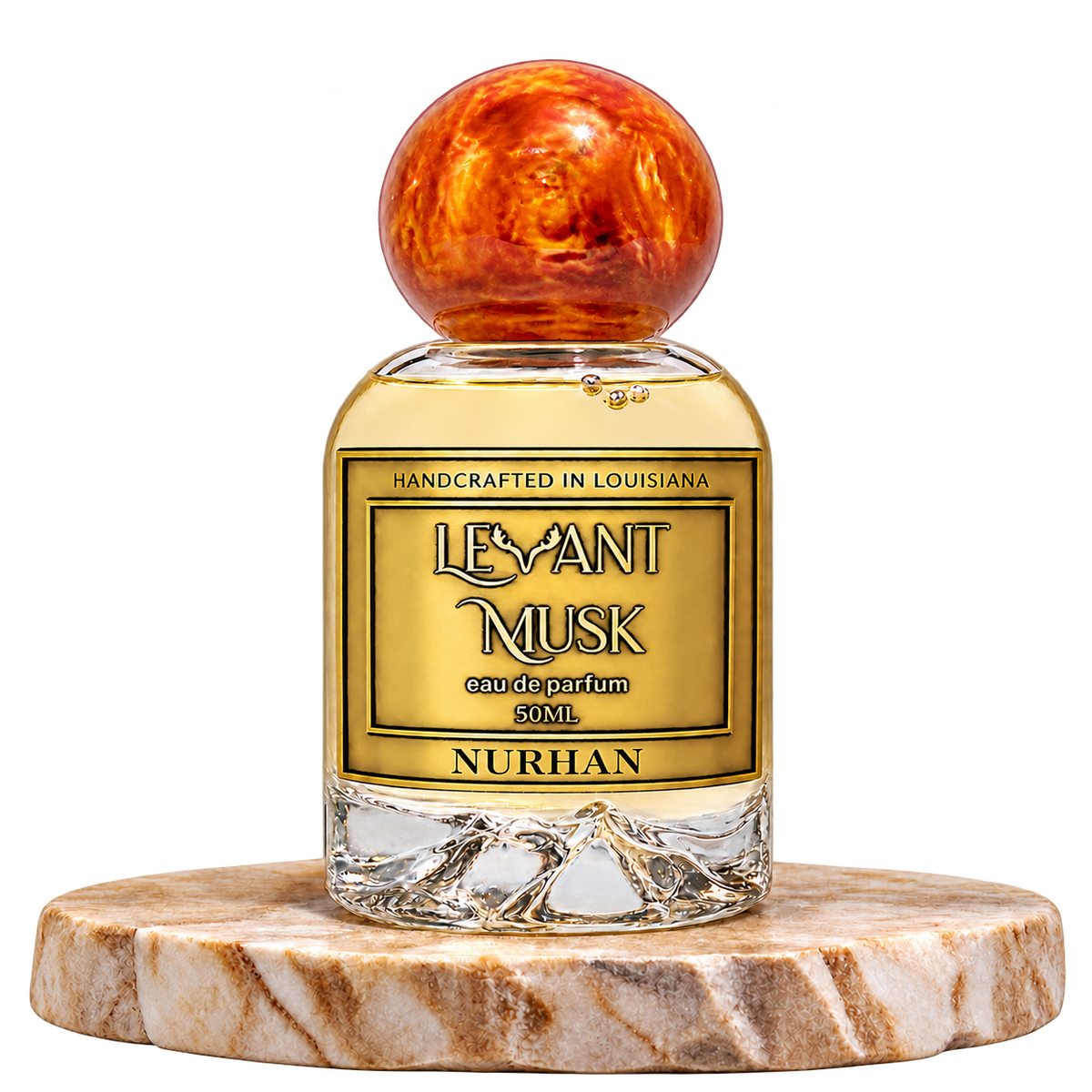 NURHAN 50 mL eau de parfum in a rounded Levant Musk bottle with orange marbled cap and gold label, on a cream marble pedestal, transparent background.