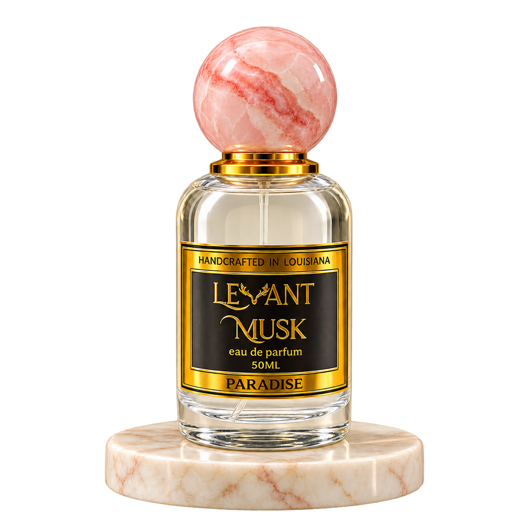 PARADISE by Levant Musk, 50 mL eau de parfum with a pink marble cap on a cream marble plinth, transparent background.