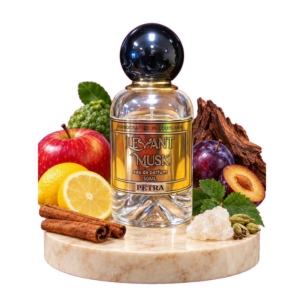 A perfume bottle labeled 'LEVANT MUSK' named Petra, displayed on a marble pedestal with fruit, spices, and wood pieces around it on a white background.