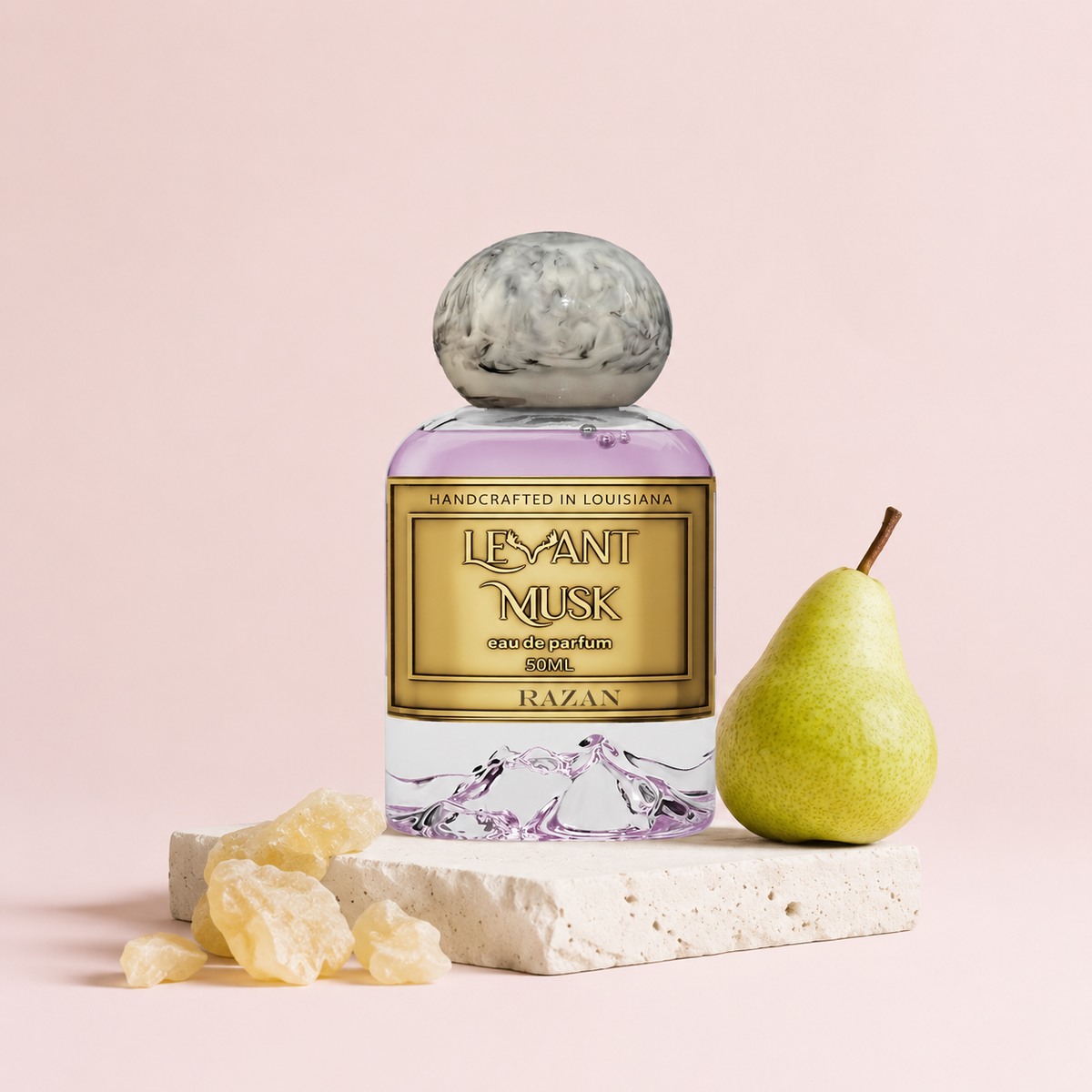 Levant Musk Razan perfume bottle styled with notes of sparkling pear, rose, and virginia cedar.