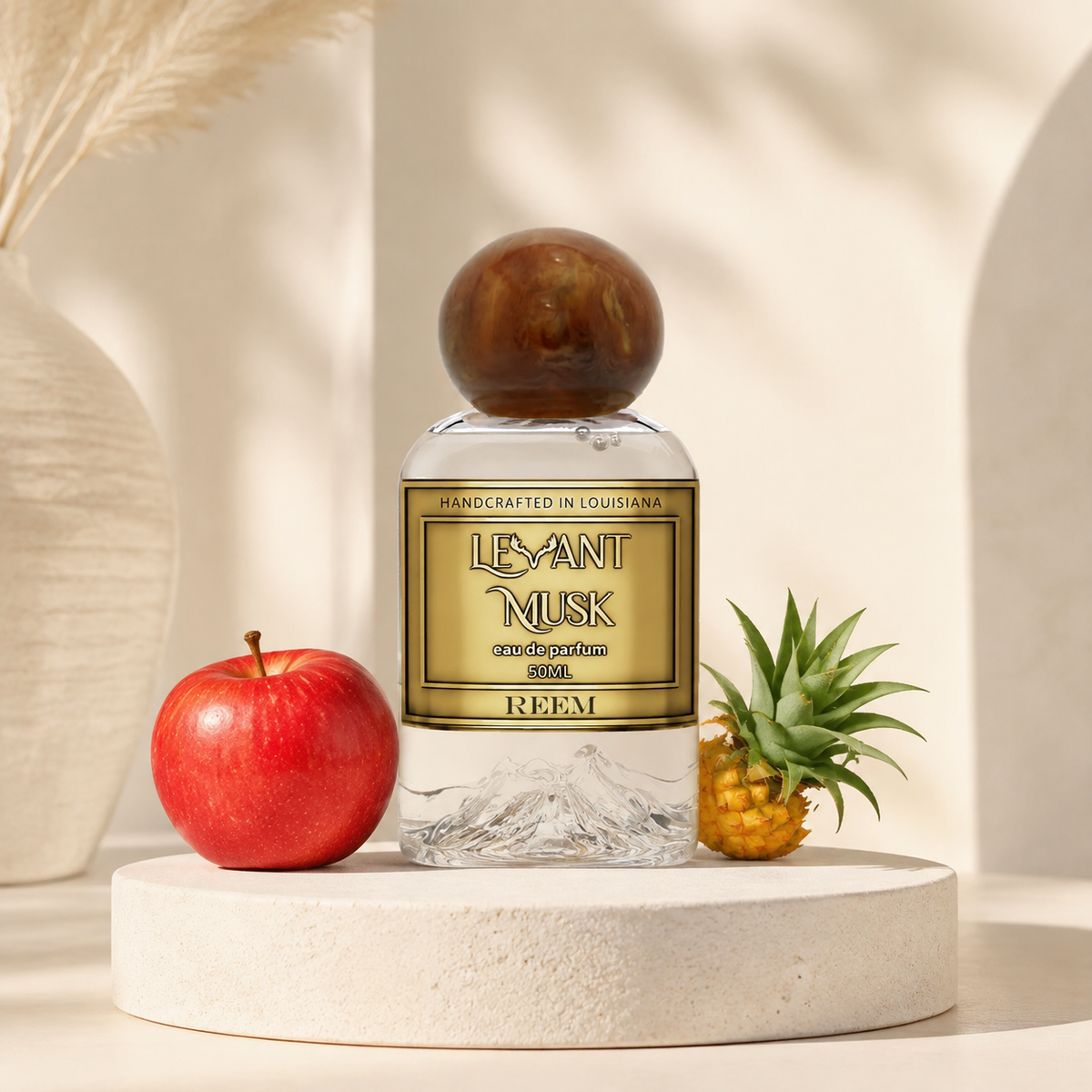 Levant Musk Reem perfume bottle styled with notes of bergamot, apple, and ambroxan.
