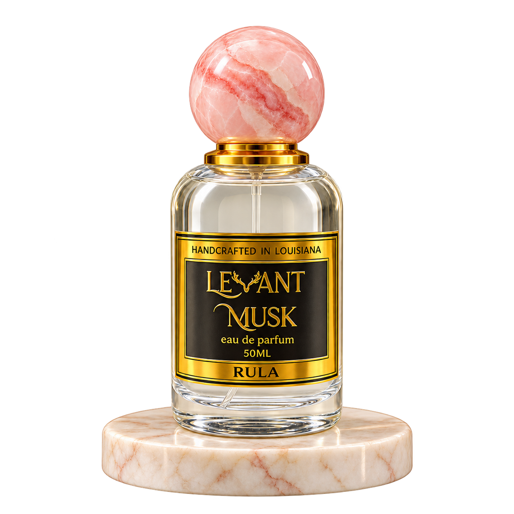 RULA by Levant Musk, 50 mL eau de parfum with a pink marble cap on a cream marble plinth, transparent background.