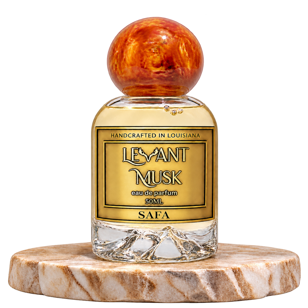 SAFA by Levant Musk, 50 mL perfume bottle with an orange cap on a cream pedestal, transparent background