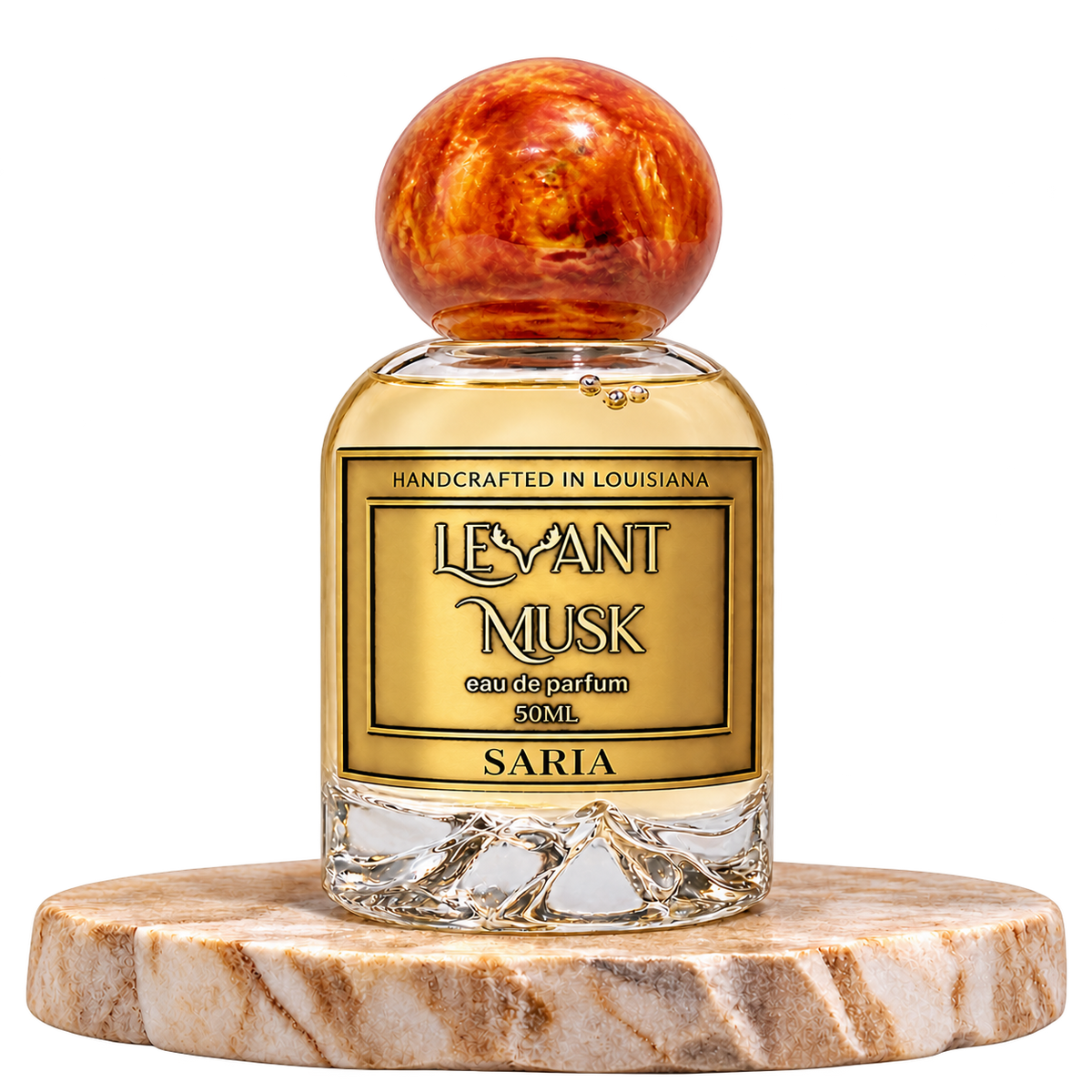 SARIA by Levant Musk, 50 mL bottle with orange-gold cap on a marble pedestal