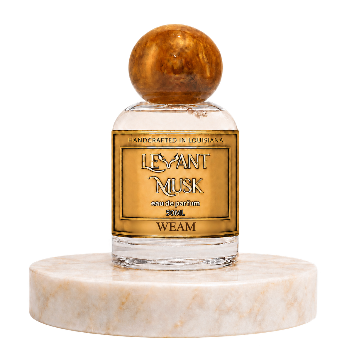 WEAM by Levant Musk, 50 mL eau de parfum with the approved antler label and orange marble cap, on a warm cream marble pedestal.