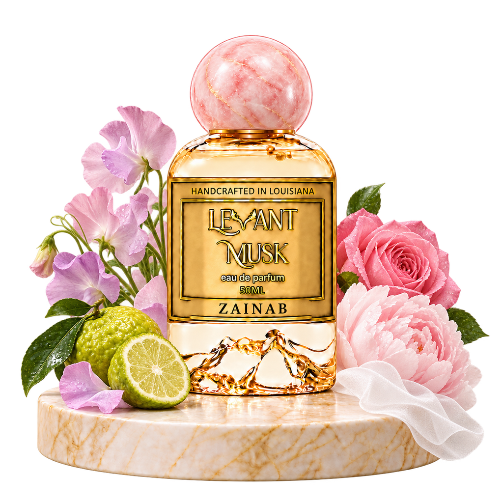 ZAINAB by Levant Musk perfume on a marble pedestal with sweet pea flowers, bergamot, pink rose, peony and white fabric.