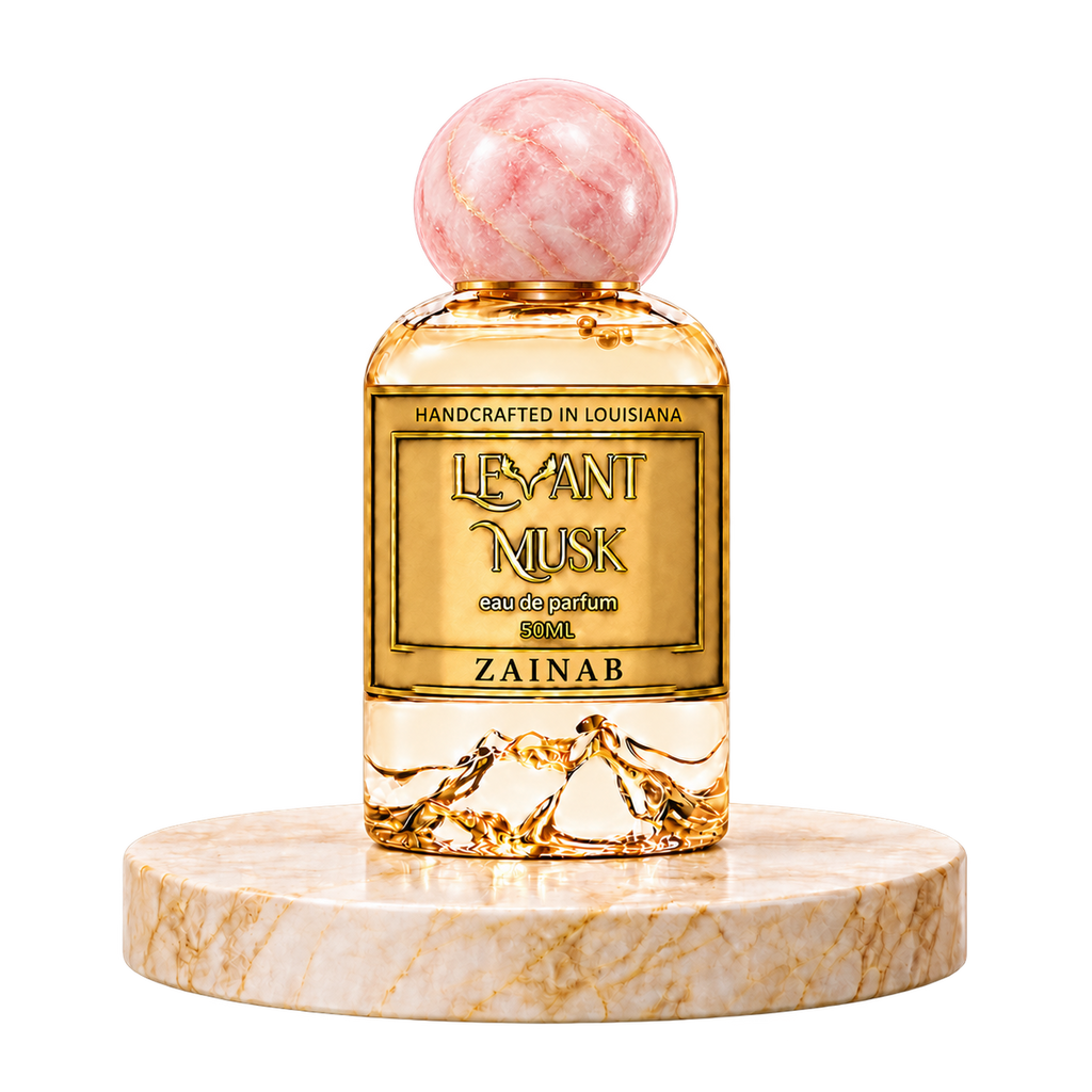 ZAINAB by Levant Musk, 50 mL eau de parfum bottle with a pink spherical cap on a round marble pedestal.