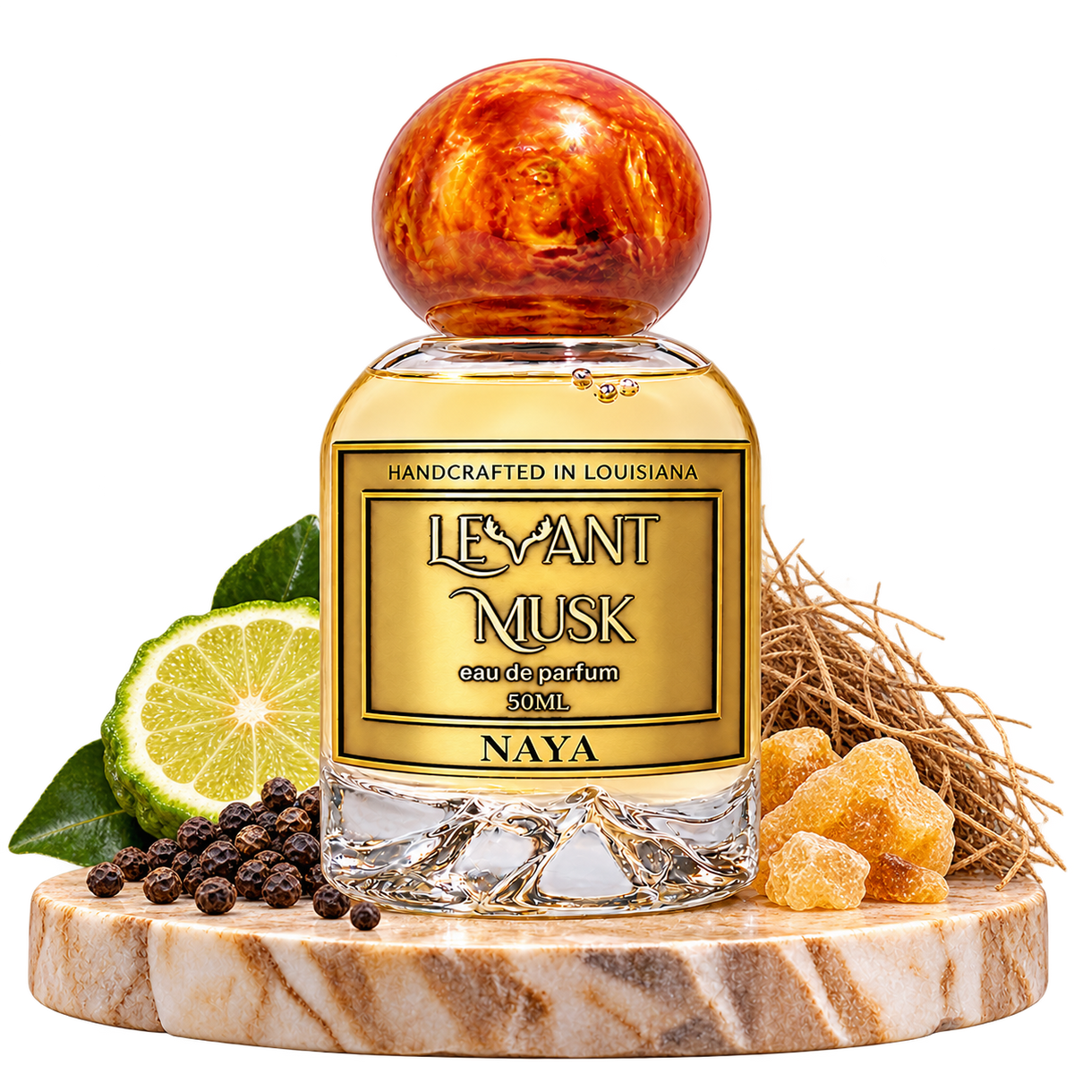 NAYA by Levant Musk, bottle with fragrance-note props on a marble pedestal