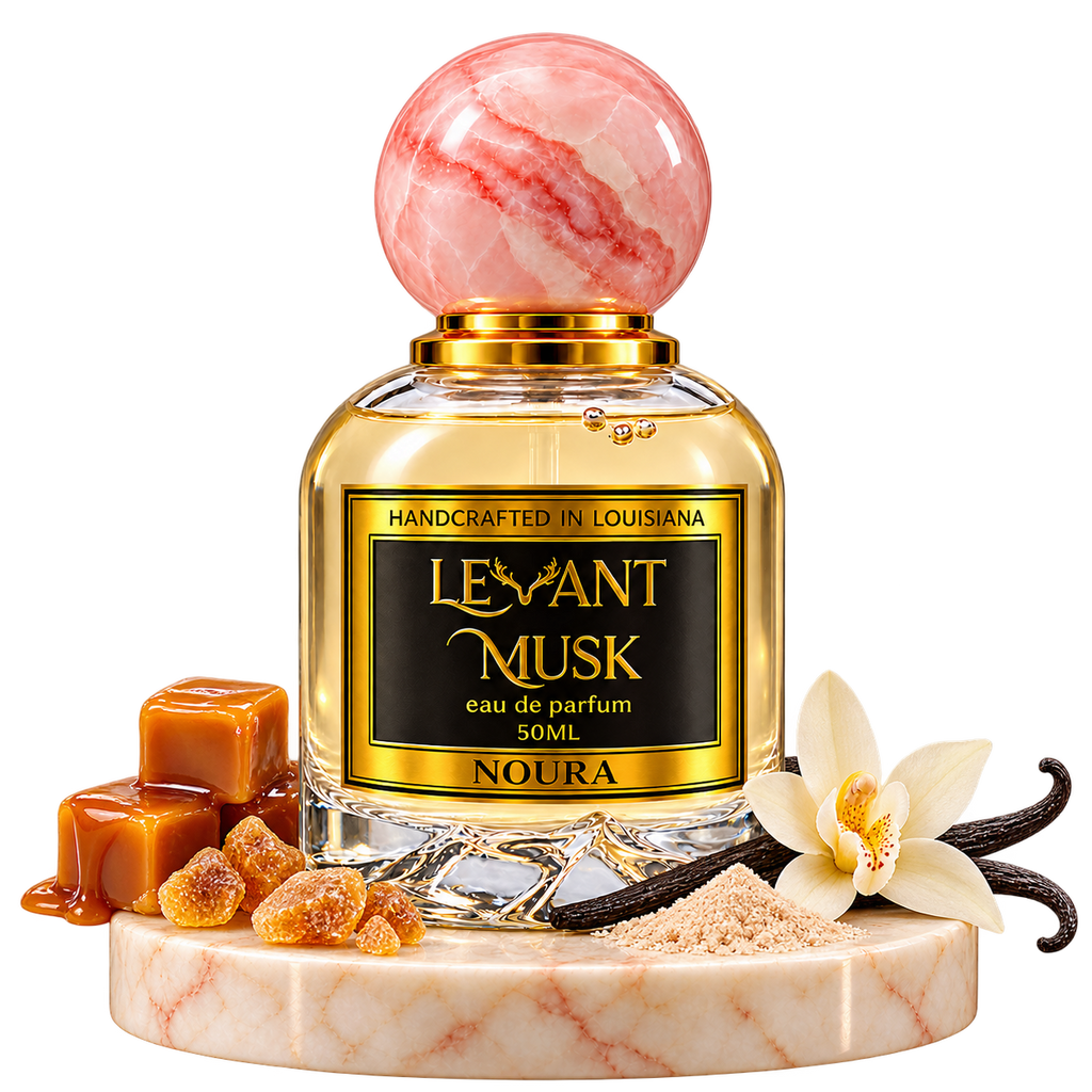 NOURA by Levant Musk, bottle with fragrance-note props on a marble pedestal